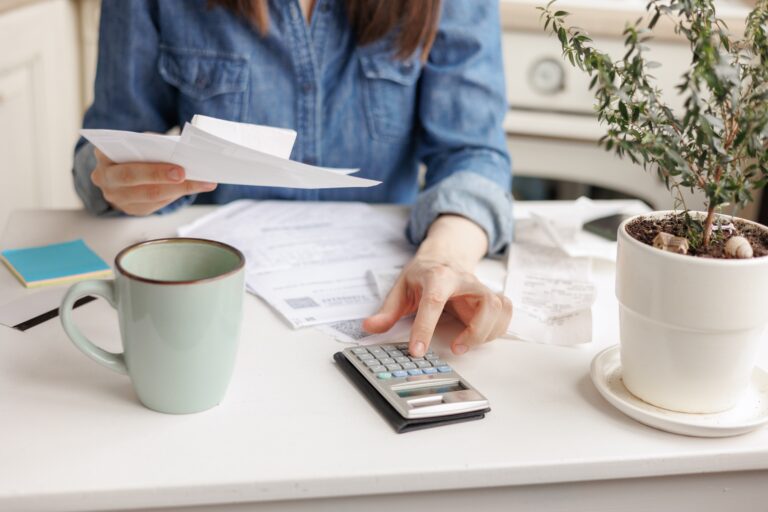 Woman,Pays,Utility,Bills,And,Writes,Checks.,A,European,Woman